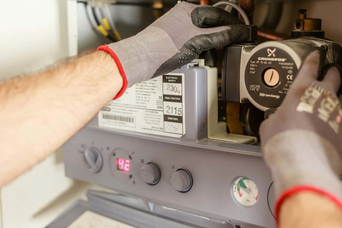 Plumber working on water heater - factors that drive up installation cost in Port St. Lucie